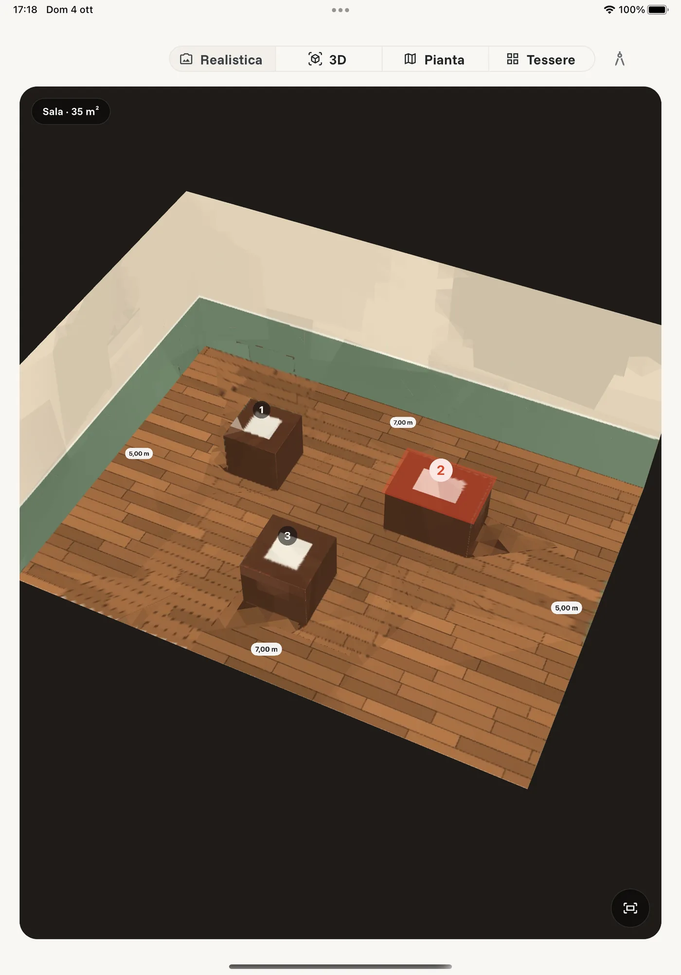 The Realistic view on an iPad: a room with a wooden floor and a brick wall, three numbered tables and wall lengths written on the floor.